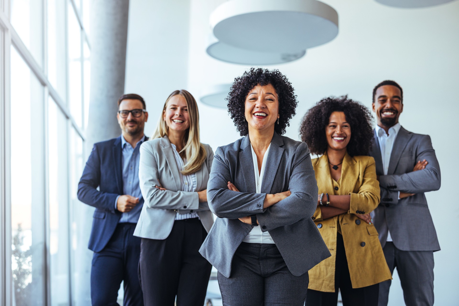 Confident Team of Professionals Standing Together in Corporate Setting
